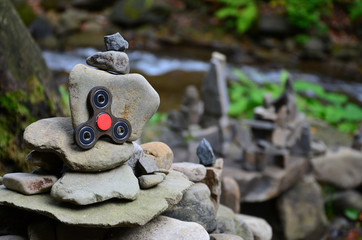 A wooden spinner lies on strange stone structures in the forest
