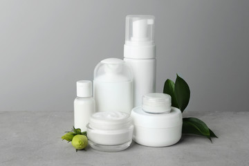 Set of body care products on grey background
