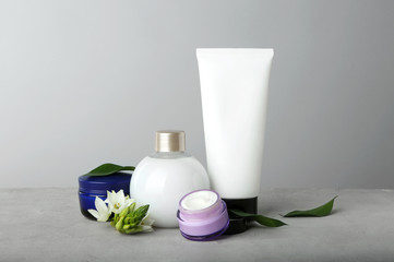 Set of body care products on grey background
