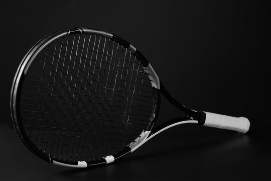 Tennis racket on dark grey background