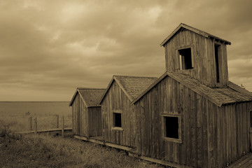 Wood Islands Provencial Park wooden fishing huts on coast in sepia