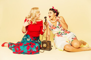 Young women talking on an old phone