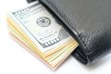 Stack of  dollar bills sticking out of wallet