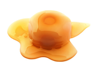 Delicious candy with caramel sauce on white background