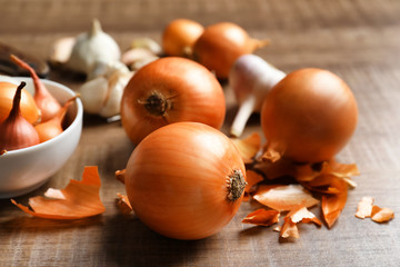 Fresh yellow onion on wooden table