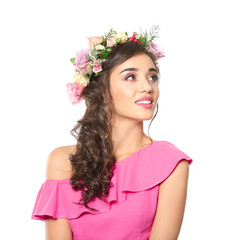Naklejka premium Young woman with floral crown and pink dress looking up, beauty and spring fashion concept, isolated on white background