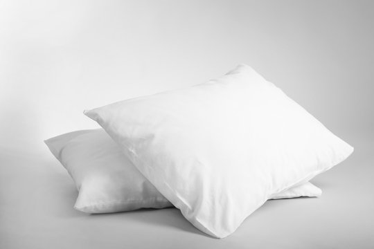 Blank soft pillows on light background