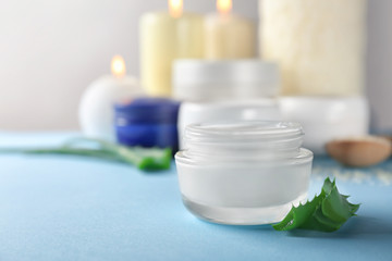 Jar with body cream on table