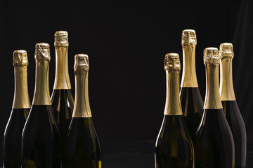 Bottles of champagne on a black background. Selective focus © Igor Dudchak
