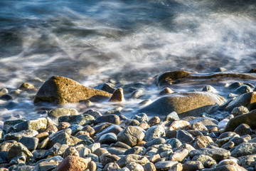 Scenic water splash and a rock in ocean