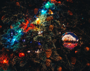 Obraz na płótnie Canvas Christmas ball and light garland on fir tree. Xmas background