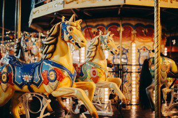 Fototapeta na wymiar Seat horse on carousel illuminated at night