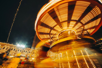 Carousel fast turning in motion illuminated at night