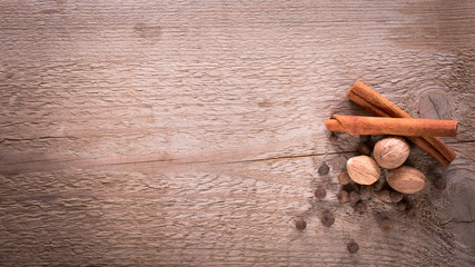 Cinnamon, allspice and nutmeg. Spices on wooden background. Natural and bio ingredients for cooking. Top view and copy space for your text.