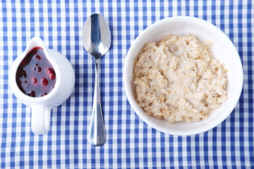 Healthy vegetarian cereal breakfast. Oats in white bowl.