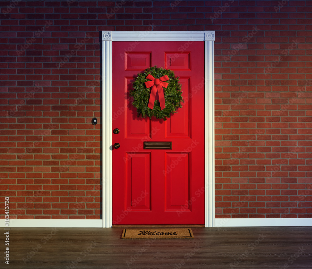 Wall mural christmas wreath on bright red front door with welcome mat.