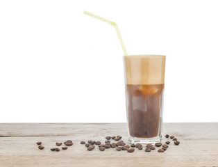 Glass of frappe coffee on wood background. Greek Frappe coffee and coffee beans. Isolated.