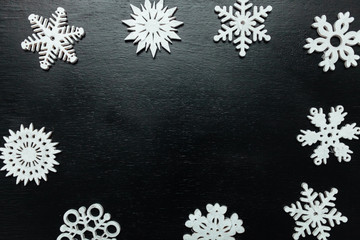 Snowflakes on a black background. Christmas toy drive.