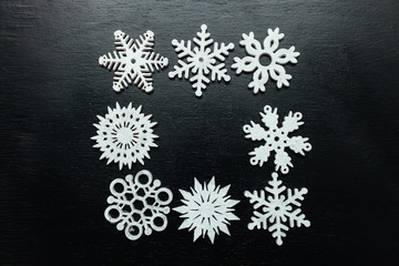 Snowflakes on a black background. Christmas toy drive.