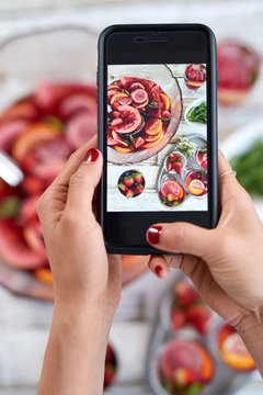 taking photo of food on mobile cell phone to share on social med