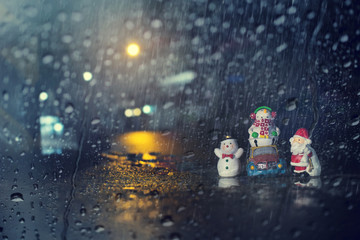 Merry Christmas and happy holidays concept background.View through the window of strong rain.