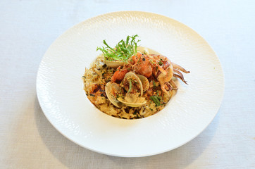 Italian seafood rice on white plate