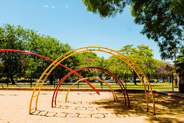 Colorful stair sail seen from front in the sandpit of a park