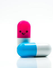 Cute blue and pink couple capsule pills isolated on white background with copy space for text. Global healthcare concept. Taking care of couple life
