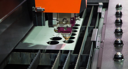 CNC fiber laser cutting machine cutting metal sheet. Industrial metalwork machinery