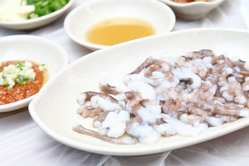 Korean sannakji (Raw Octopus tentacles) meal. Octopuses are often killed before cut into small pieces with tentacles still moving when served.
