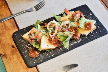  Mexican seafood salad on black slate plate 