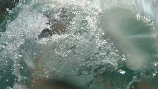girl on pedal boat pulls off the hill into the sea, view from water
