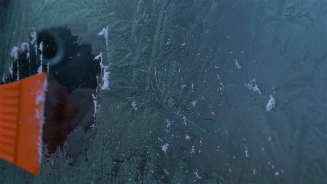 Scraping ice from windshield