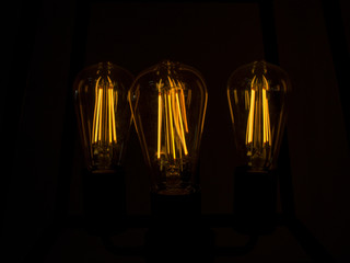 Yellow light bulbs in darkness