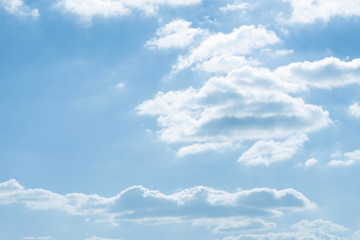 Blue sky background with white clouds.