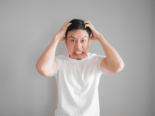Very angry aggressive man portrait in white t-shirt.