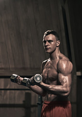 Fototapeta na wymiar Weight training man in the gym