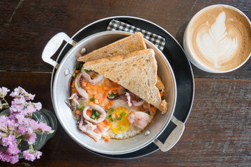 Breakfast,Pan-fried egg, pan omelet with seafood topping and toast