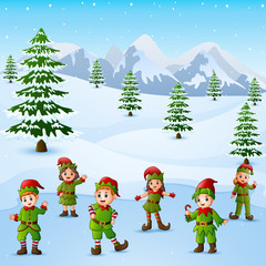 Happy kid wearing elf costume in the snowing hill