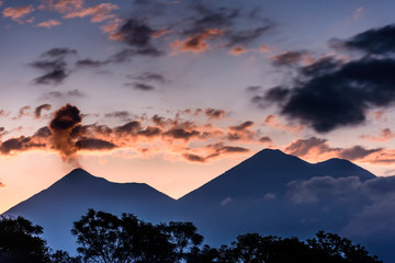 Puffs of smoke erupt from Fuego volcano next to Acatenango volcano, near Antigua, Guatemala, Central America