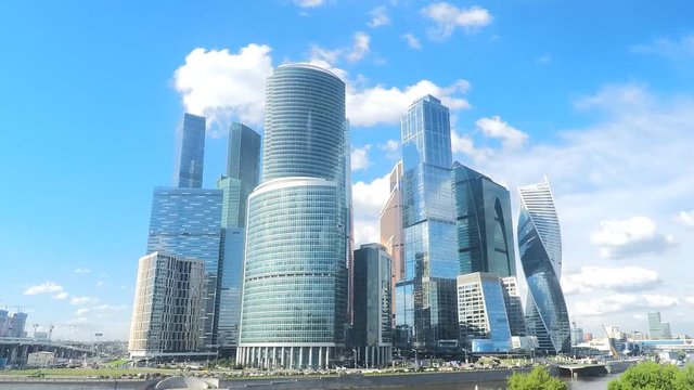 modern glass skyscrapers on river bank in summer timelapse