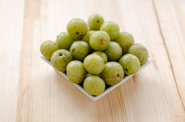 Indian Gooseberry: berry of high vitamin-c on the wooden background