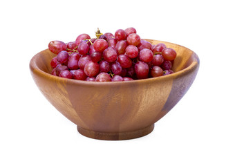 Ripe fresh red, purple grapes in a natural wood bowl isolated in white background.