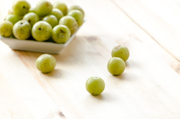 Indian Gooseberry: berry of high vitamin-c on the wooden background