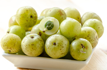 Indian Gooseberry: berry of high vitamin-c on the wooden background