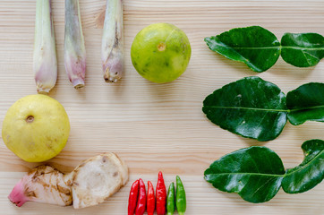 Herb ingredient of Tom Yum spicy soup Thai food cuisine on wooden background