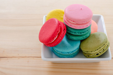 Colorful macaroons on wooden table background