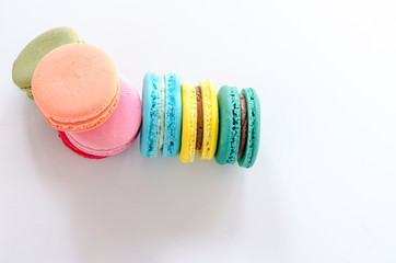 Colorful macaroons on white table background