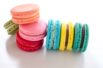 Colorful macaroons on white table background