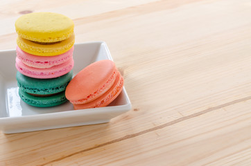 Colorful macaroons on wooden table background
